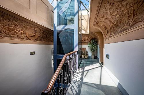 a hallway with a spiral staircase in a building at Martelli 6 Suite & Apartments in Florence