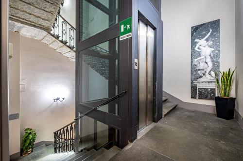 an open door in a hallway with a staircase at Martelli 6 Suite & Apartments in Florence
