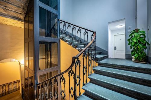 a staircase in a house with a potted plant at Martelli 6 Suite & Apartments in Florence