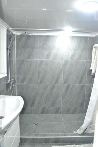 a bathroom with a shower and a sink at Family & Relax Loft Lake House in Zagalʼtsy