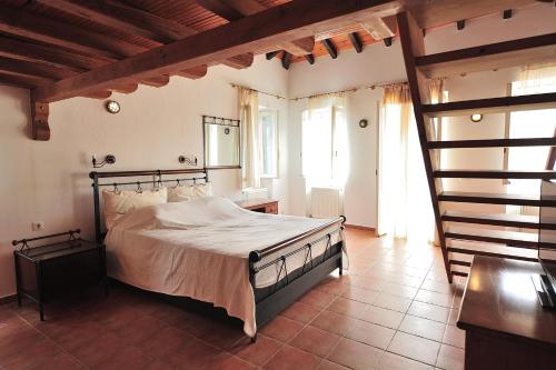 a bedroom with a large bed in a room at Orestis Mansion Skiathos in Skiathos
