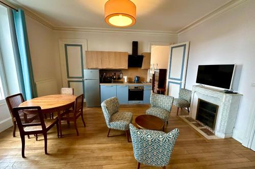 a kitchen and dining room with a table and chairs at Neuchâtel in Vaudoncourt
