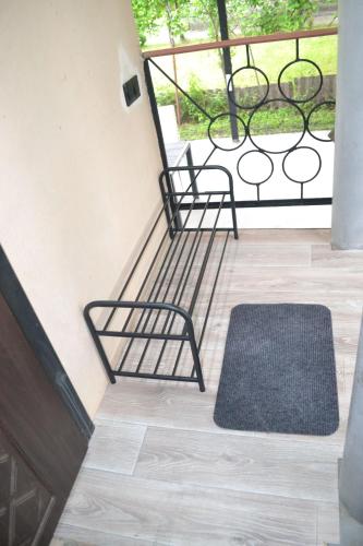 a balcony with two chairs and a rug at Family & Relax Loft Lake House in Zagalʼtsy
