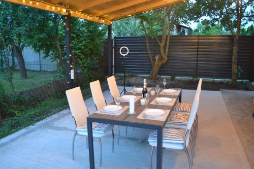 a wooden table and chairs sitting under a pergola at Family & Relax Loft Lake House in Zagalʼtsy