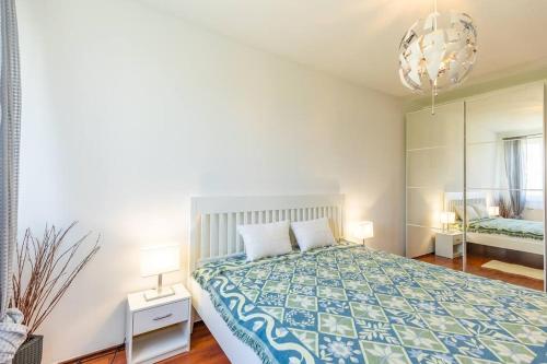 a bedroom with a bed and a large mirror at Danube View Apartment - Bodor utca in Budapest