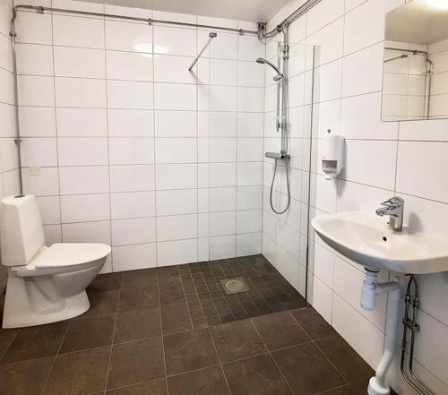 a bathroom with a toilet and a sink and a shower at Sidsjö Hotell & Konferens in Sundsvall