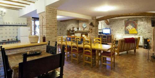 a kitchen and dining room with a table and chairs at Hotel Rural Villa Liquidámbar in Torrecilla en Cameros
