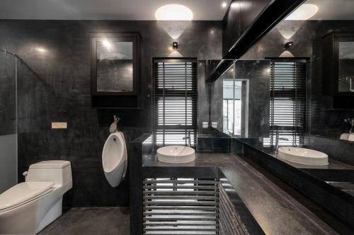 La salle de bains est pourvue de 2 toilettes, d'un lavabo et de toilettes. dans l'établissement Villa Jacuzzi R6 The Height Khaoyai 1BR byน้องมังคุด, à Ban Huai Sok Noi