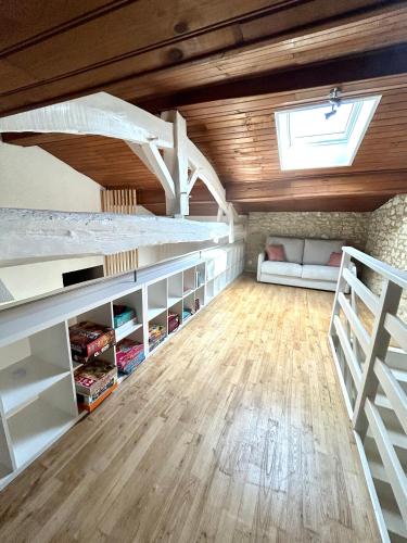 a room with a bunk bed and a couch at Gite de La Rastelle au coeur de la nature in Savignac-de-Duras