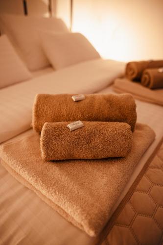 a pile of towels sitting on a bed at Holiday House Drava Relax in Pitomača