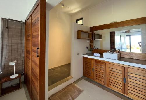 a bathroom with a sink and a shower and a counter at COCO MANGO Villa in Trèfles