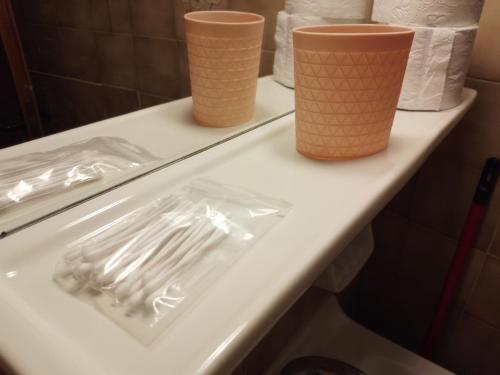 a counter with three plastic forks and cups on it at Loggia in Agia Galini