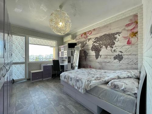 a bedroom with a map of the world on the wall at Апартамент Чаролит / Apartment Charoite in Burgas City