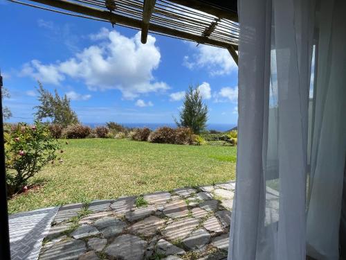 a view of a yard from the window of a house at COCO MANGO Villa in Trèfles