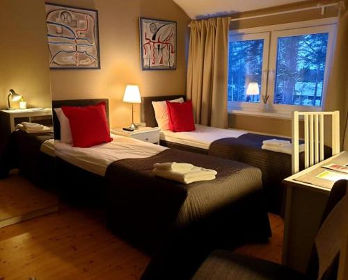 ein Hotelzimmer mit 2 Betten und einem Fenster in der Unterkunft Norppa Resort in Savonlinna