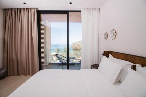 Postel nebo postele na pokoji v ubytování Hotel Olympia Touristic Village