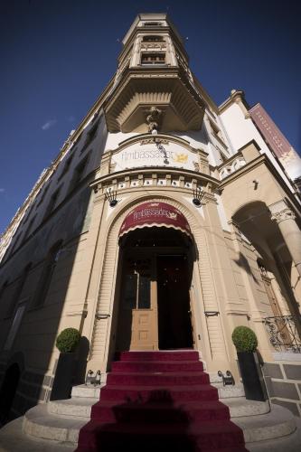a building with stairs leading up to a building with a tower at Grandhotel Ambassador Národní Dům in Karlovy Vary