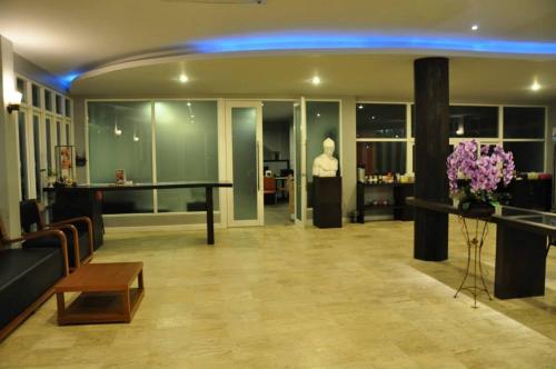 a lobby with a table and a man in the background at Khaoyai Terrazzo in Mu Si