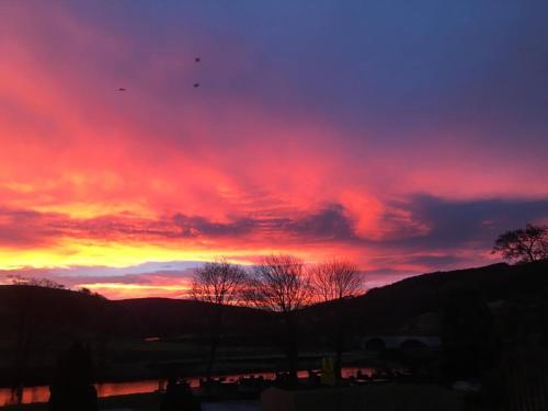 a sunset with a purple and red sky at Wharfe View B&B in Burnsall