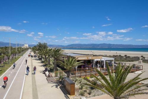 a street with palm trees next to a beach at Room in Guest room - La Palma Royal Room Summer in Cagliari