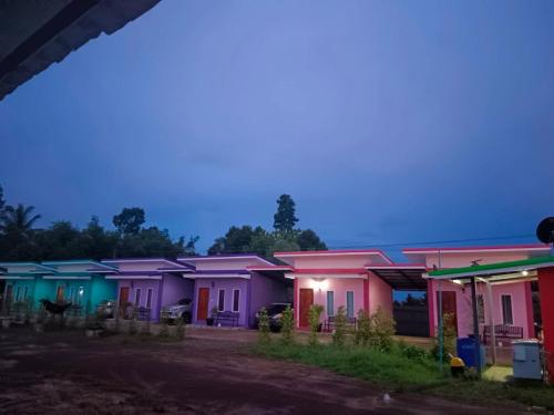 a row of colorful houses at night at JUNPEN RESORT in Ban Hai Yong