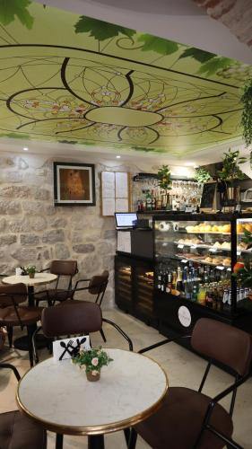 een restaurant met tafels en stoelen en een bar bij Apartments Wine House Old Town in Kotor
