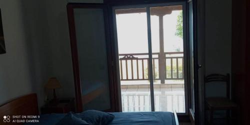 a bedroom with a door open to a balcony at il corallaro in Ierissos