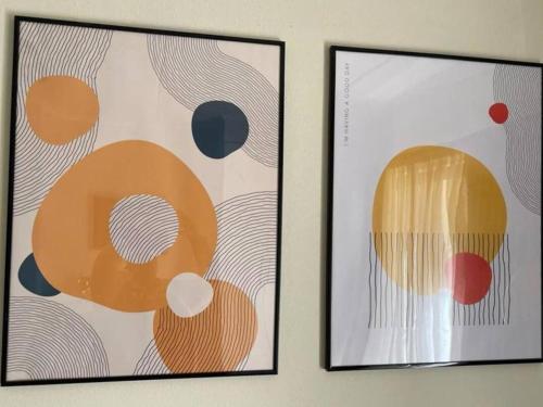 two framed pictures hanging on a wall at Executive Modern Apartment in Fourways