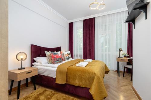 a bedroom with a bed with a yellow blanket on it at Luxurious & Unique Apartment Mickiewicza Cracow by Renters Prestige in Kraków