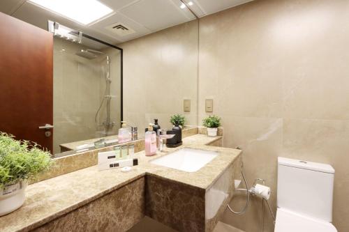 a bathroom with a sink and a mirror at Chic 1BR Next to Dubai Marina Promenade by Livbnb in Dubai