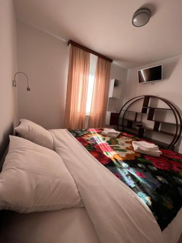 a bedroom with a bed with a colorful blanket on it at Les gîtes du Valjoly 1 in Touvent