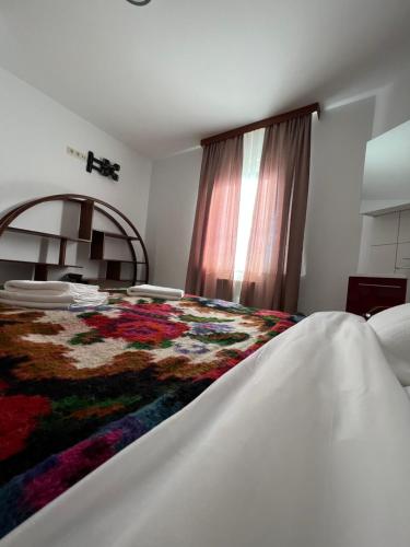 a bedroom with a bed with a colorful blanket on it at Les gîtes du Valjoly 1 in Touvent