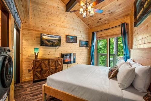 a bedroom with a bed in a log cabin at Sunrise View Chalet in Gatlinburg