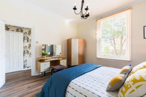 a bedroom with a bed and a desk at Garden Apartment in Listed Building in Leamington Spa