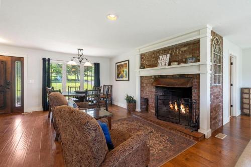 a living room with a fireplace and a couch at Lake Escape Lakefront Lodge at Red Bud Cove in Hollister