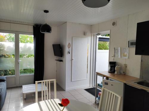 a kitchen with a table and a counter top at Chalet 38 m2, au calme reposant, près du puy /fou in Saint-Pierre-des-Échaubrognes