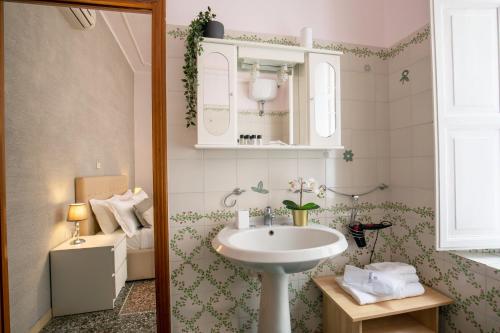 a bathroom with a sink and a toilet at Baldassini Suites in Rome