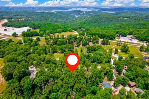 an aerial view of a house with a red circle in the trees at Dogwood Tree Cabin in Ridgedale