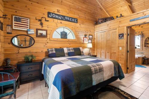 a bedroom with a bed in a wooden cabin at Dogwood Tree Cabin in Ridgedale