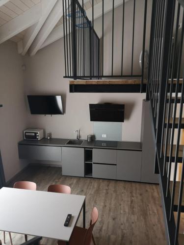 a kitchen with a staircase and a table and chairs at Suite Apartments in Cervia