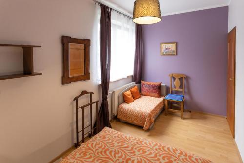 a living room with a chair and a window at Kordeczki-Apartamenty i pokoje in Rabka-Zdrój