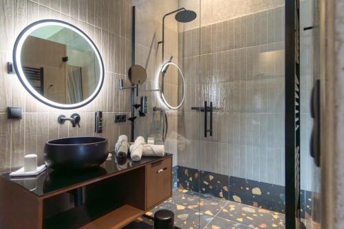 a bathroom with a sink and a mirror at Lifesteil Aparthotel in Umhausen