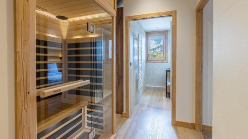 a room with a walk in closet with glass doors at Résidence W 2050 - BELLE PLAGNE in Belle Plagne