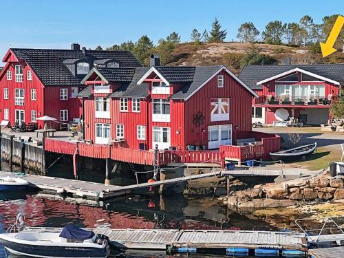 a group of red houses with boats in the water at 8 person holiday home in averøy-By Traum in Averoy