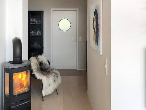 a room with a door with a dog sitting next to a fireplace at 8 person holiday home in averøy-By Traum in Averoy