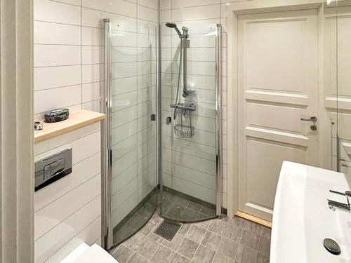 a shower with a glass door in a bathroom at Holiday home averøy III in Averoy