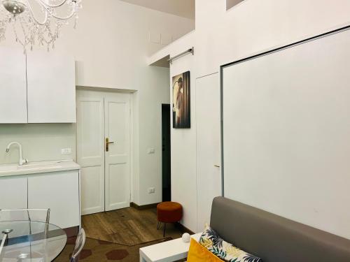 a living room with a glass table and a kitchen at La Vaticana in Rome