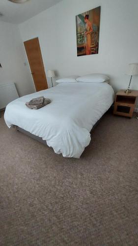 a large white bed in a room with at Strathalban cottage in Aberlour