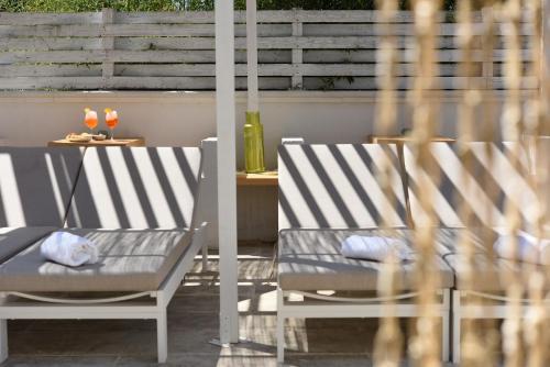 two chairs and a table on a patio at Residenza Il Sole in Monopoli