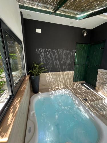 a hot tub in a room with a window at Romantic apartments in Šibenik